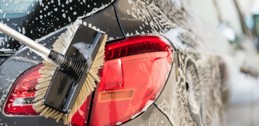 Washing a car with scrub brush