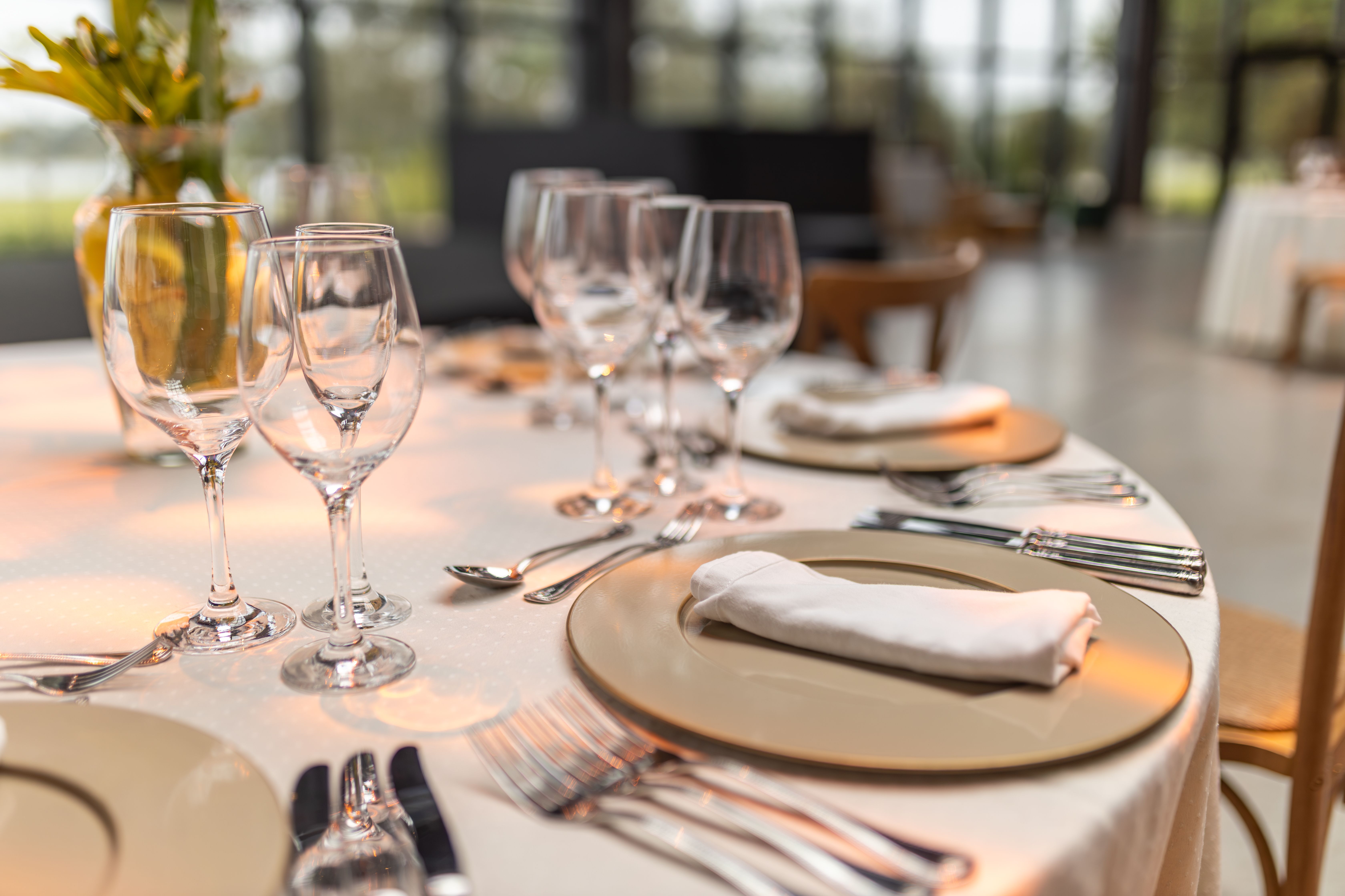 Sophisticated fine dining table setting with glassware and napkins prepared with high-end service detail
